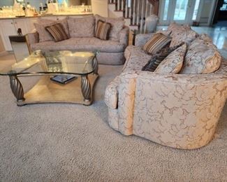 2 matching Bernhardt sofas with curved arms and pillows, amazing coffee table with matching end table.