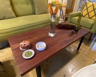 Solid wood top with heavy iron base rectangular coffee table by West Elm