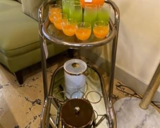 Vintage mid century modern 1950s lime green blendo  picture with glasses. Very unique mid century bar cart oval shaped two-tier mirrored bottom glass top.