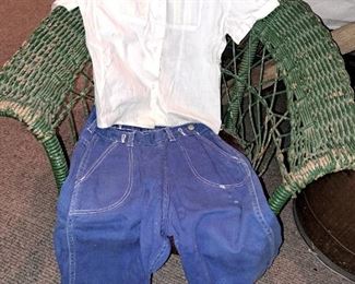 Vintage children's items. Green wicker children's rocker and children's clothes