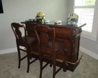 Bar with brass foot rail and matching bar stools 2 Titans football helments