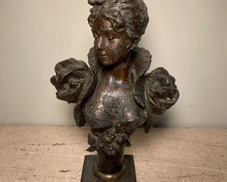 Metal bust of lady
