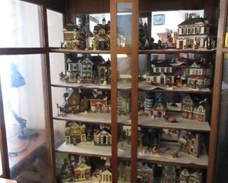 Antique solid oak curio cabinet shown with the Christmas village