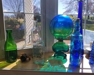 Colored glass bottles and oil lamp