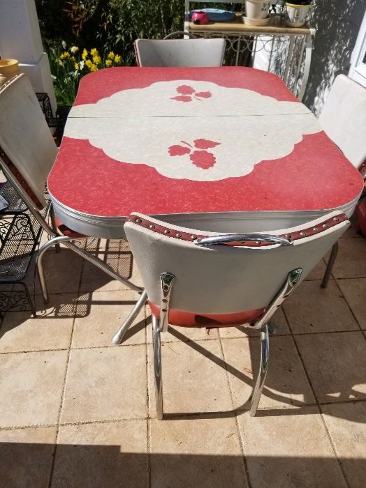 Gem of a retro dinette set featuring chrome table/ fabulous flower design  formica top and set of 6 matching chrome & vinyl chairs. All original!