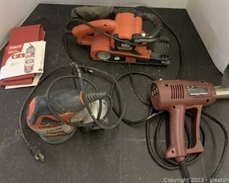 Three Power Tools in White Bucket and Sanding Belts