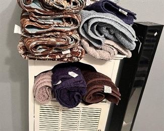 Cute little white storage cabinet.
New Teal and brown towels, and Misc. bath towels.