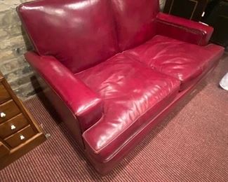 Red leather loveseat with nailhead trim