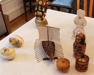 A Swiss cowbell and Russian nesting dolls and other Russian wooden works.