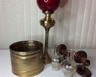Lamps & Sconces
Tall brass-like oil lamp with red globe - H30"; (2) wall candle sconces with wooden plaques and glass globes - H16"; and copper-colored bucket - 10" round