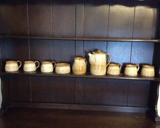 Pottery Tea Set
(9) piece pottery tea set. No distinguishable marks. Includes (6) mugs, (1) pot, (1) creamer and (1) sugar bowl