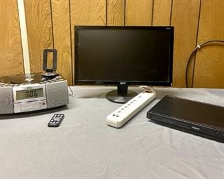 Wedge CD Player/Alarm Clock and More
AM/F stereo model A4116 with remote; Acer monitor - 18" Model P186H; Philips DVD Player, no remote, Model DVP36801F7; Prime Power surge cord. All items power on.