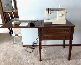 Singer Merritt Sewing Machine Table and Machine
Sewing Machine Table. Total open measurements H 29" x W 50" x D 20". 15" ruler measurement printed on table. Singer sewing machine. Merritt model 4528. Instruction manual included. False drawer opens to thread storage. Medium wood color.