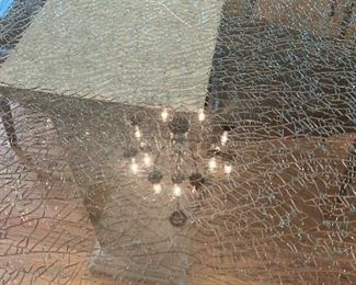 Custom table with Intentional Cracked glass on custom stand that also lights up and changes color.  