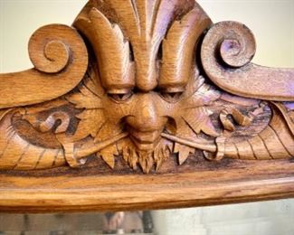 Antique wood-framed mirror and man's face with horns