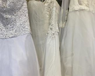 Three designer wedding gowns.