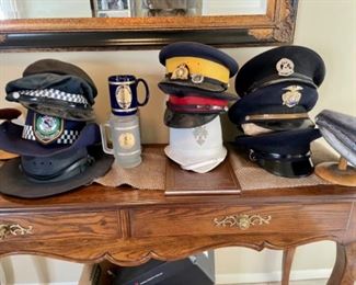 Collection of Obsolete Vintage military and police helmets, hats and badges 