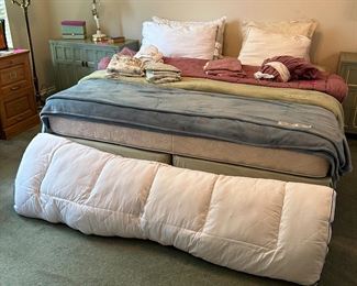 King Size bed with linens and pillows and blankets