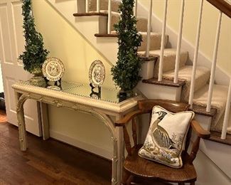 Antique Wedgwood plates, mirror top console, wooden captains chair and needlepoint down pillow