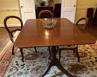 Antique mahogany cross-band double pedestal dining table and antique Victorian chairs 