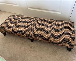 Fabric covered low bench, made with antique pew legs