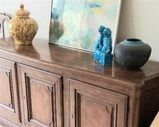 Stylish credenza with pottery and original art