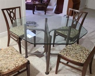 Glass table and set of chairs for sale. Table and chairs may be sold separately 