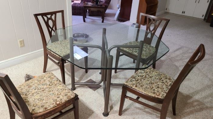 Glass table and set of chairs for sale. Table and chairs may be sold separately 