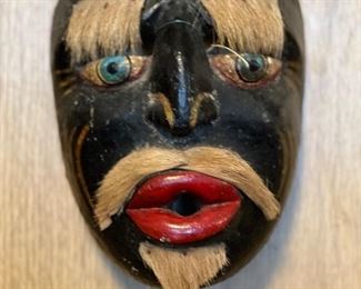 Carved mask with animal fur