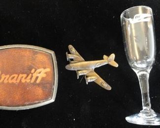 Braniff Airlines belt buckle, wings and stemware