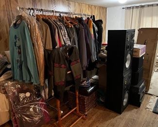 There is a standing valet partially hidden under the jacket and in front of the clothes rack.  