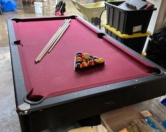 And this is the pool table with the rack, all the balls, and four cue sticks.