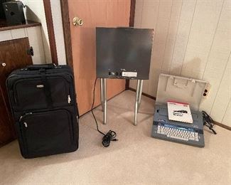 Travel bag, 35 MM viewer table, and vintage electric typewriter