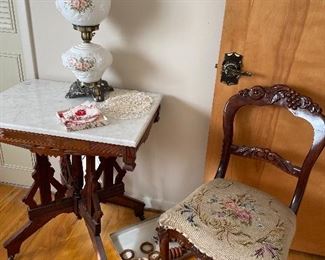 Marble topped table, porcelain lamp, and mahogany chair with needlepoint upholstery