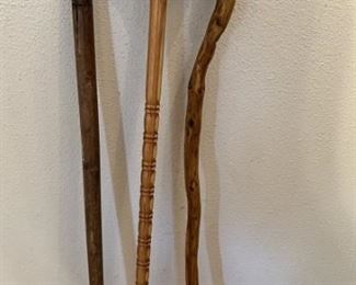 (3) Canes: 1- Carved Handle, 1- Curved Handle Cane
1- Natural Wood Walking Stick
