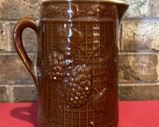 Brown Pottery Pitcher with Grape Pattern