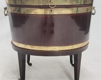 2016 - English oval lift top cellaret, brass trim 26 x 24.5 x 18 lined & separated interior, handles on side, casters
