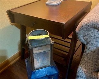 That interesting item on the floor, right there is an old coin collector from a trolley. Notice the side table here, we have three of these just alike.