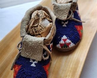 Pair of blue beaded child's moccasins with leather soles