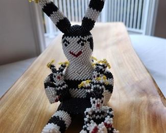 Fully beaded "Storyteller" doll with small dolls, signed C. Cellicion