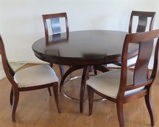 Round table with 6 chairs and extra leaves.
