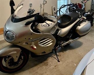 Triumph Trophy 1200 Motorcycle 1999 one owner and 28,883 miles. It comes with 2 hard saddle bags and on detachable hard shell trunk for additional storage. Full face helmet, Triumph riding boot and triumph cycle cover also comes with a box of spare parts ( brake pads, oil filter etc priced at $3600