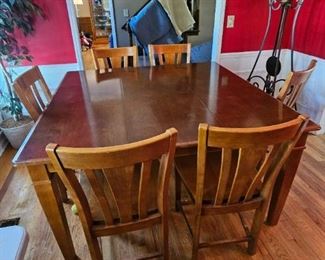 Tall table with 6 tall height chairs.                                                            Table 5'L x 5'W   32" high                                                                               Chairs 32" high  