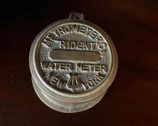 Brass water meter cover container.