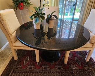 A wonderful Pedestal Black Marble Top Table with Four Padded Chairs.  A Handwoven Persian Carpet. 