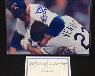 AUTOGRAPHED NOLAN RYAN PHOTO OF HEADLOCK & UPPERCUTS TO ROBIN VENTURA FOR RUSHING THE MOUND,