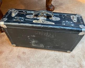 Vintage Bassett leather suitcase with chrome metal detail and early Dunwoody Industrial Institute pennant sticker 