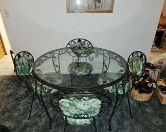 Vintage green wrought iron dining set.  Round, glass top table and 4 matching chairs.