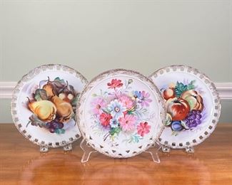 (3pc) SIGNED PORCELAIN PLATES | Hand-painted and signed porcelain plates with reticulated borders and floral / fruit motifs
Dimensions: dia. 8 in