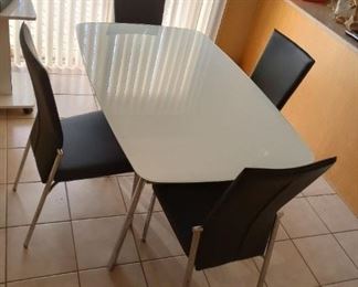 Was $1400. New, 3 yrs ago, now asking only $800. For the like new mint set, white Glass topped Ultra Modern dining room table, $800. Come try it out!